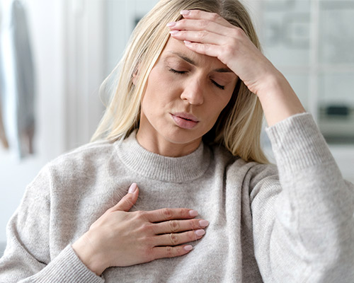 Woman feeling unwell holding head